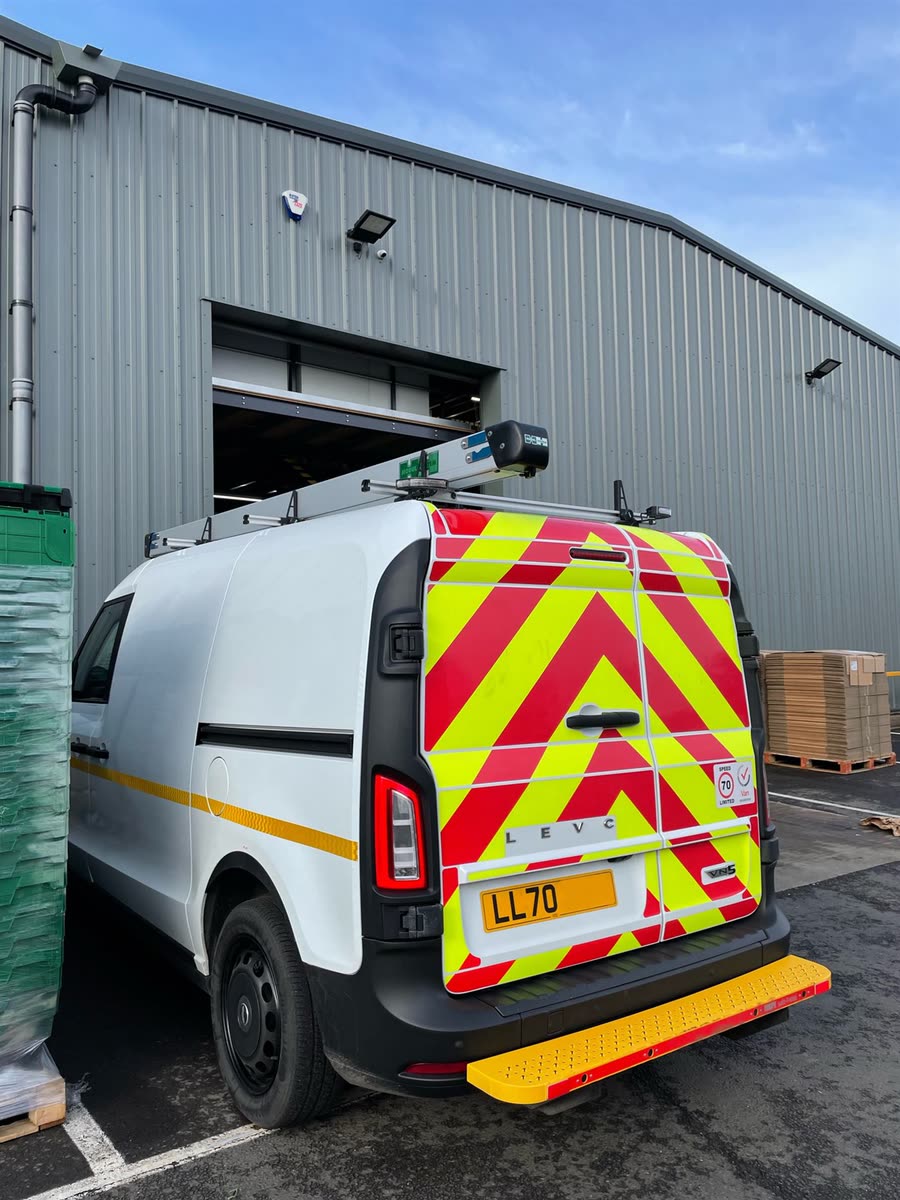 An electric collection van and returns totes at our loading bay