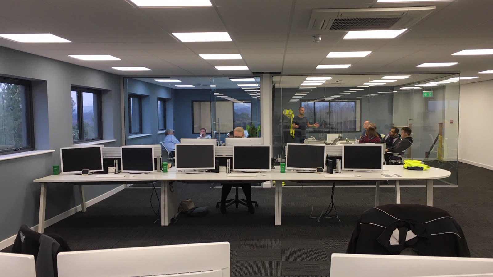The same room in use — the team working at their desks on the first morning