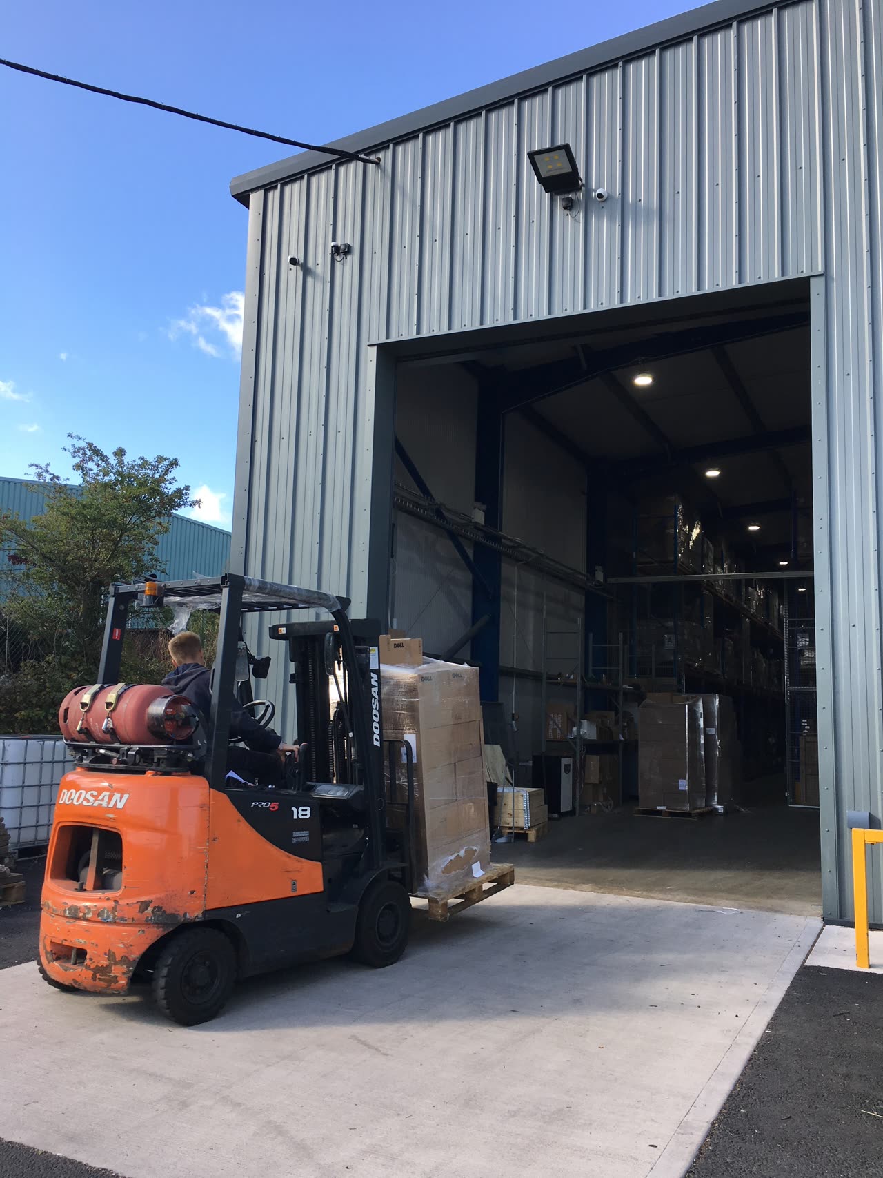 A forklift loading pallets at the goods-in door of a Greensafe facility