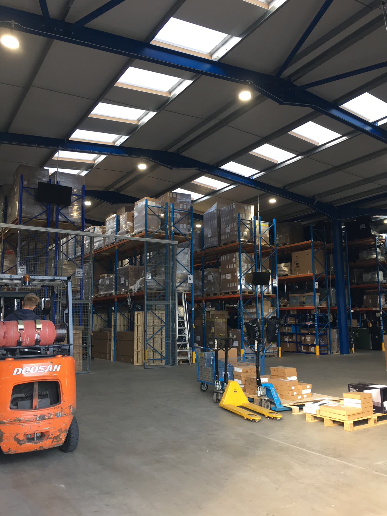 The warehouse floor with pallet racking and handling equipment