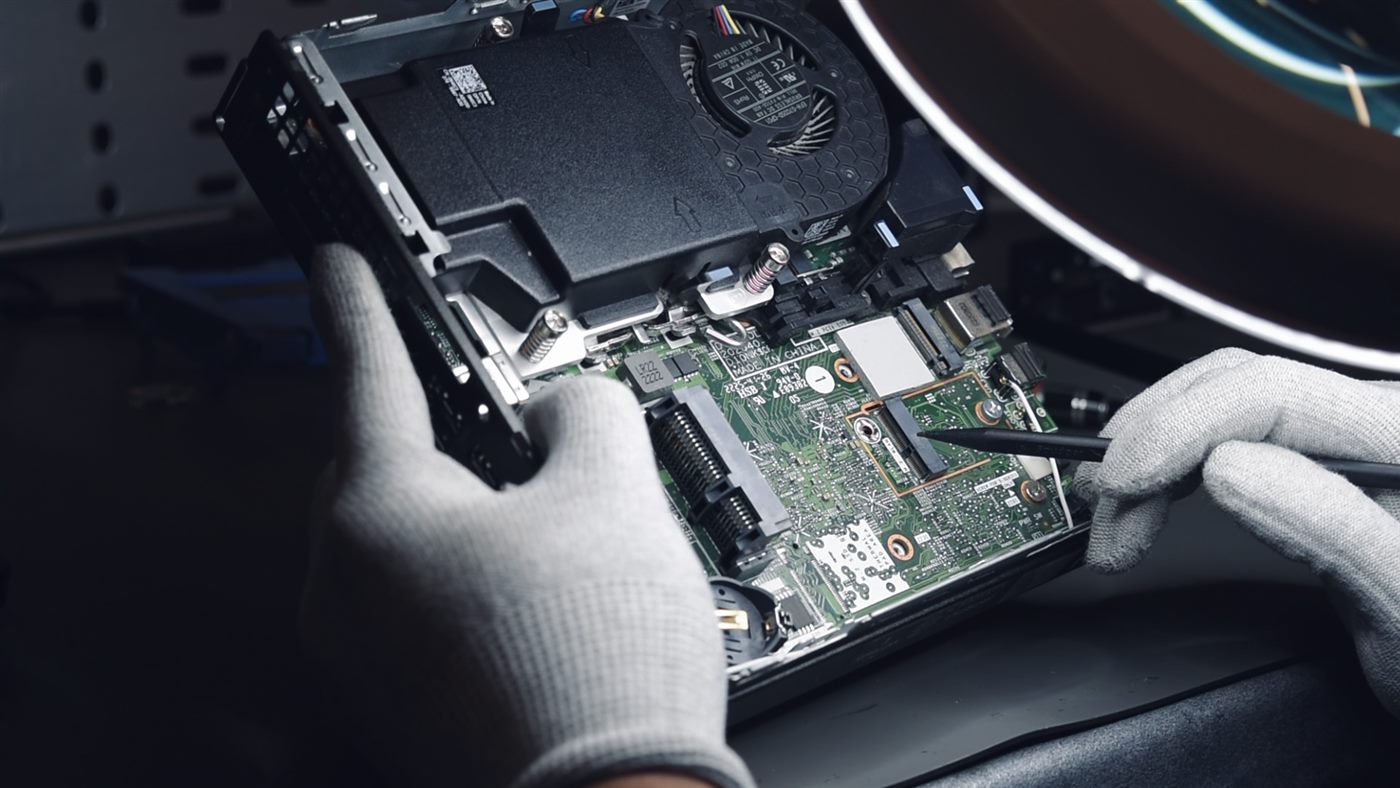An engineer carrying out component-level repair on a laptop mainboard