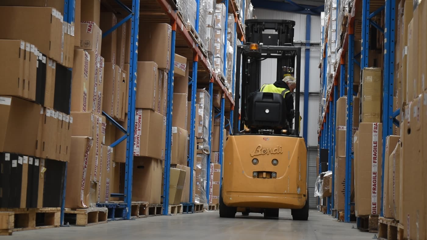 A forklift working a full racking aisle in the bonded warehouse