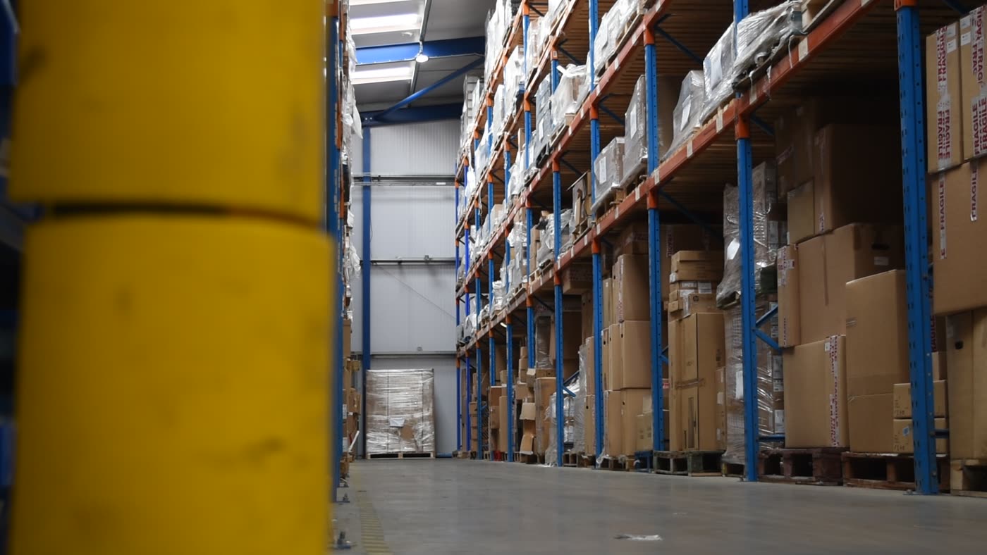 A long racking aisle of palletised stock