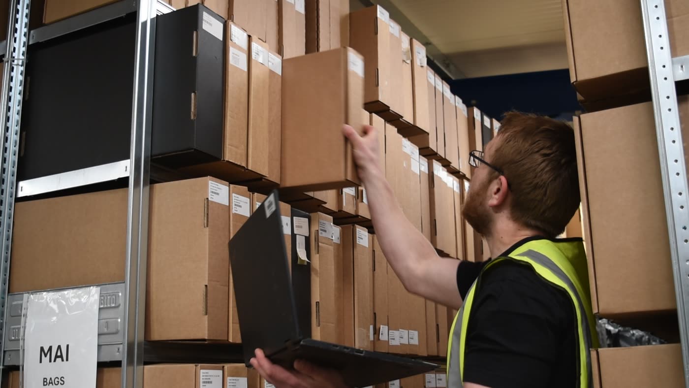 An operative checking labelled stock against its rack location