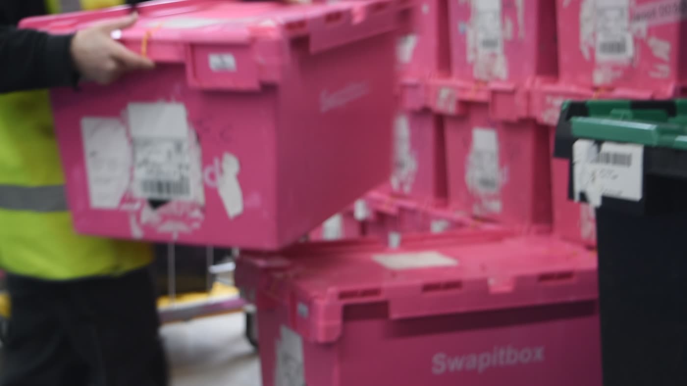 Sealed stock totes stacked and staged in the warehouse