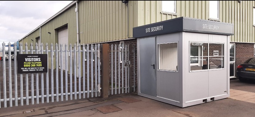 The Kidderminster site security gate and hut, with the visitors telephone sign on the palisade fence